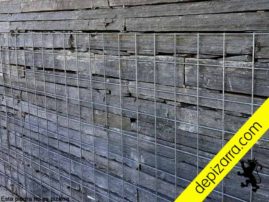 Muros de piedra con malla metálica.