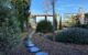 Jardín mediterráneo con grava y vegetación.