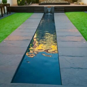 Pavimento de pizarra natural en jardín con fuente de agua